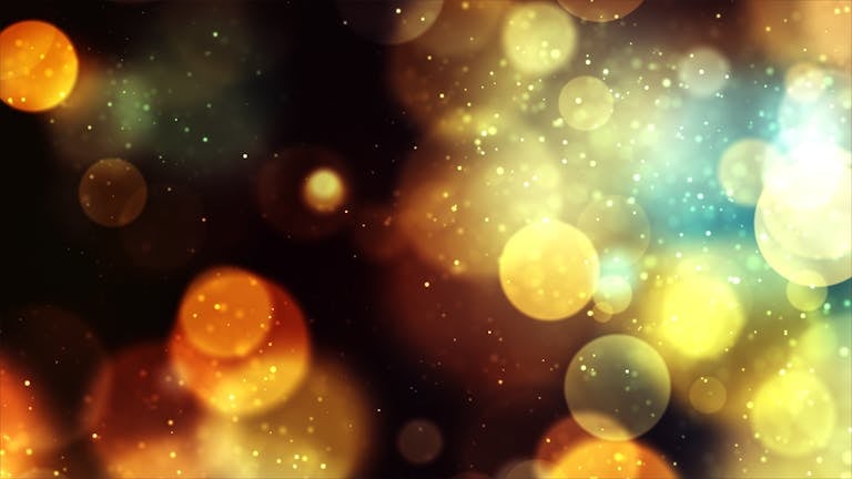 Vibrant bokeh background with golden and blue lights creates a magical and festive atmosphere.